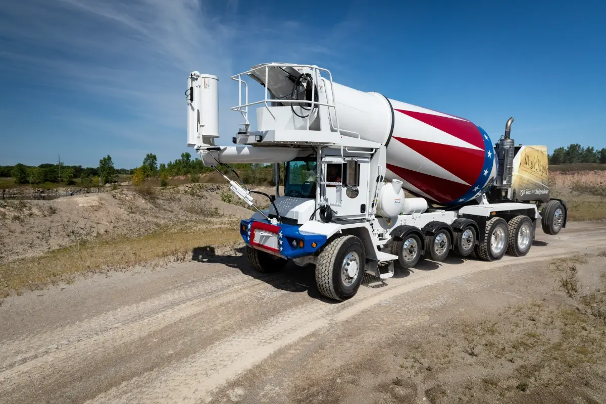 Oshkosh S-Series front-discharge concrete mixer truck in a patriotic red, white, and blue design. Oshkosh S-Series front-discharge concrete mixer truck in a patriotic red, white, and blue design.