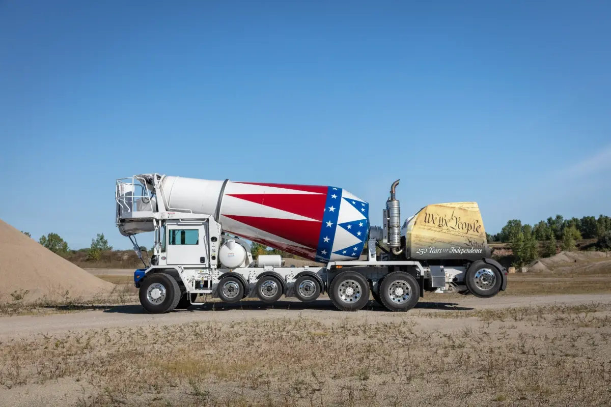 Oshkosh S-Series front discharge concrete mixer truck with a patriotic drum and high-lift tag axle configuration. Oshkosh S-Series front discharge concrete mixer truck with a patriotic drum and high-lift tag axle configuration.