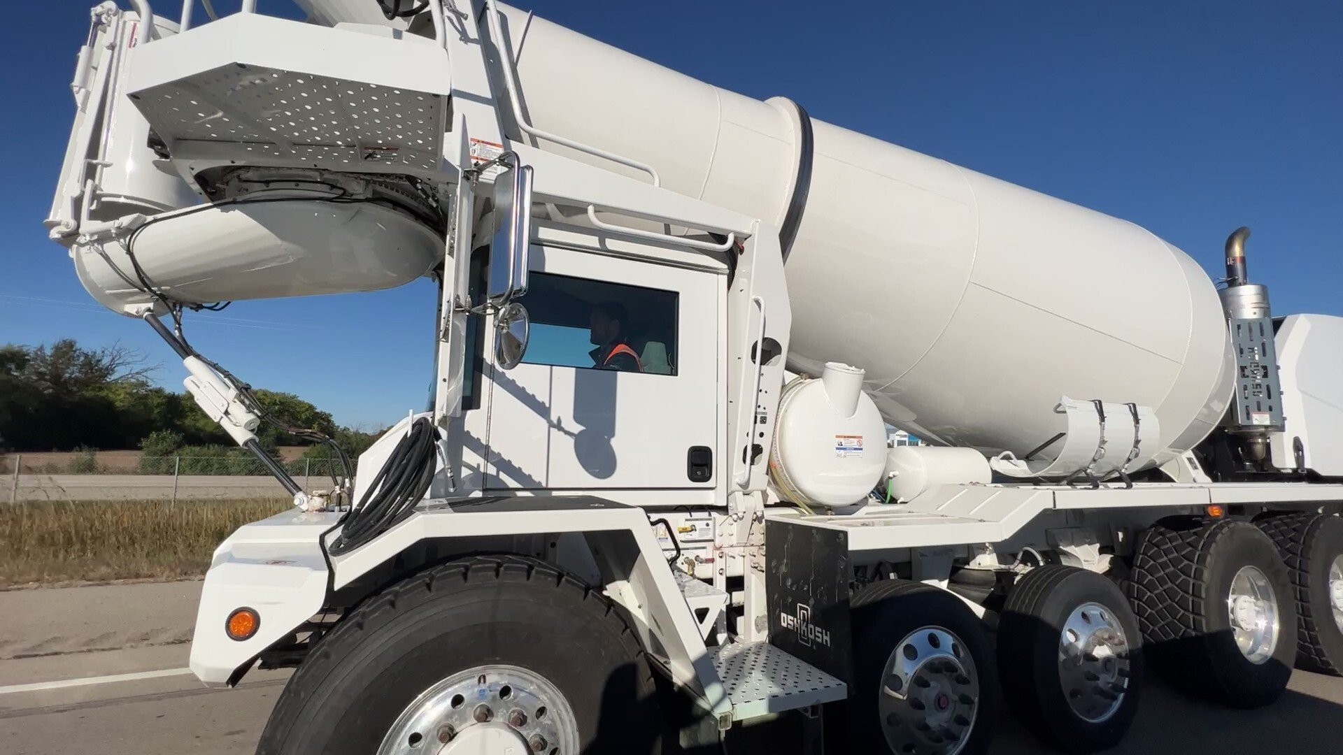 Operator driving an Oshkosh® S-Series™ front discharge concrete mixer